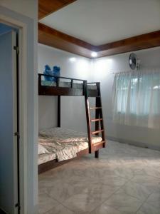 a bedroom with two bunk beds in a room at Dhong and Eden Home in San Vicente