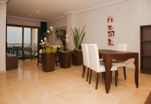 a dining room with a table and white chairs at Hotel Rural Quinto Cecilio in Medellín