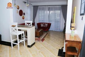 a living room with a table and a couch at Igwe Homes - Kisaasi in Kampala