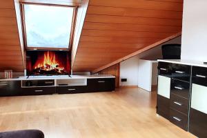 a living room with a fireplace in the attic at Studiowohnung SchwabenALB mit Panoramablick in Albstadt