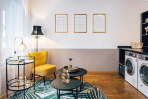 a living room with a washing machine and a yellow chair at Townhouse Berlin in Berlin