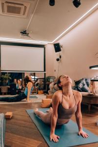 a woman sitting on the floor in a yoga class at Selina Camden in London