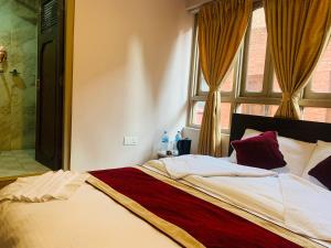 a bedroom with a large bed with a window at Hotel Central Bhaktapur in Bhaktapur
