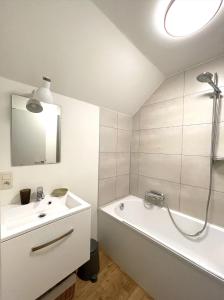 a bathroom with a sink and a bath tub and a mirror at La ferme du Bailly in Couvin +83 photos