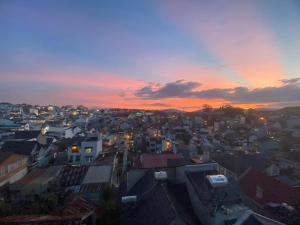 a view of a city at sunset at Mi Casa Homestay in Da Lat