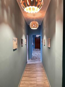 a hallway with blue walls and a chandelier at Interno2 Bari Centrale in Bari