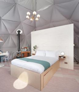 a bedroom with a large bed in a tent at The Dome at Mid Auchengowan in Lochwinnoch