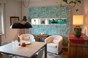 un comedor con mesa, 2 sillas, mesa y mesa en Caserma Ederle Budget Apartment x3 en Vicenza