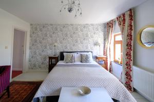 a bedroom with a large bed and a window at Collier's B&B in Bruges