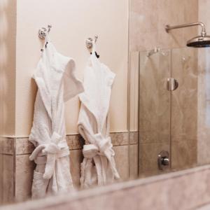 a bathroom with white towels hanging on a wall at Salotto delle Arti in Modena +33 photos