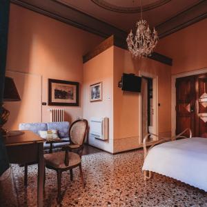 a bedroom with a bed and a living room at Salotto delle Arti in Modena