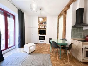 a kitchen with a table and chairs in a room at El Tesoro de Malasaña in Madrid