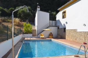 a swimming pool in front of a house at Villa Cristina in Benaoján