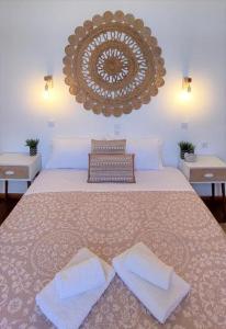 a bedroom with a large bed with two towels on it at Casa di Syrii in Ermoupoli