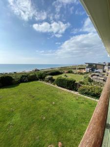a view of the ocean from the porch of a house at Sea View 5 Bed House Next To Water Sports & Golf in Porthcawl