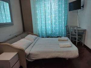 a bedroom with a bed with two towels on it at Happy Rome in Rome