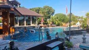 a group of people in a swimming pool at Butsaba Garden Resort in San Pāyang