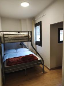 a bunk bed in a room with a window at APT 1 Acollidor al Centre Històric de Vic APTGARBI in Vic
