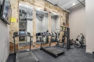 a gym with several tread machines in a room at The Davis Lofts at Main Street - Unit 3D in Rocky Mount