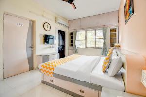 a bedroom with a large bed and a window at FabHotel Corporate Residency in Pune