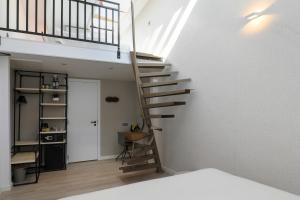 a staircase in a room with a white wall at Valerius Boutique Hotel in Wormer