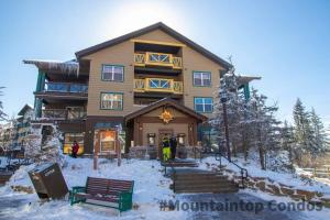 a large building with people standing outside in the snow at ML229 Mountain Escape! Great for relaxing! 2BR 2BA in Snowshoe