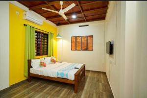 a bedroom with a bed and a television in it at Kalapurayil Residency in Kakkanad