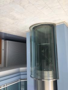 a glass elevator in a building with a window at Apartamento en Playa Capellans in Salou