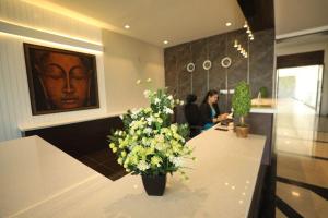 a lobby with a table with flowers on it at VRR Astoria Hotel & Convention Center in Bengaluru +52 photos
