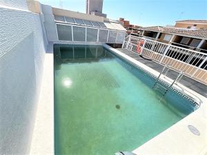a swimming pool on the side of a building at Apartamento Grao de Moncofar REF. 041 in Moncófar