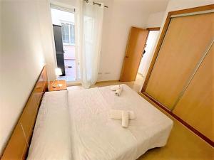 a bedroom with a bed with two white towels on it at Apartamento Grao de Moncofar REF. 041 in Moncófar +18 photos