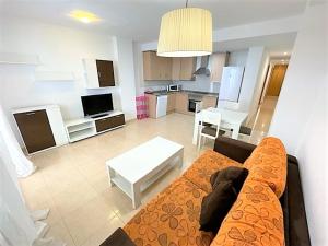 a living room with a couch and a kitchen at Apartamento Grao de Moncofar REF. 041 in Moncófar