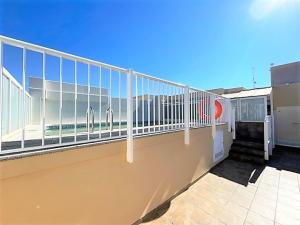 a balcony with a white railing on a building at Apartamento Grao de Moncofar REF. 041 in Moncófar