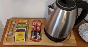 a coffee pot on a wooden cutting board with snacks at Fener sweet in Istanbul