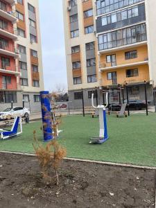 an empty playground in front of a building at Уютная квартира-студия ЖК Теремки in Almaty