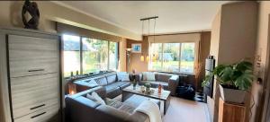 a living room with two couches and a table at Vakantievilla Het Dunehuys in De Panne