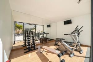 a gym with treadmills and cardio equipment in a room at Vila Baleira Funchal in Funchal
