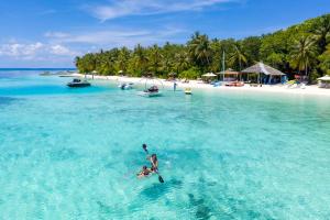 two people in a kayak in the water on a beach at Lily Beach Resort and Spa - All Inclusive in Dhangethi