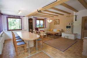 a kitchen and living room with a table and chairs at Ferienhaus Weiler im Allgäu in Weiler in Allgau