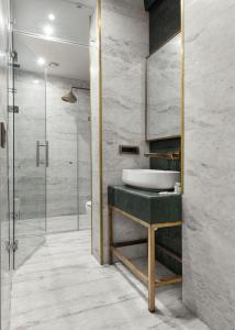 une salle de bain avec un lavabo et une douche en verre dans l'établissement Pera Rasso Hotel, à Istanbul