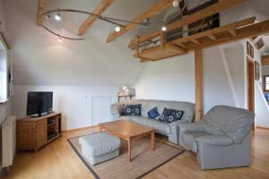 a living room with a couch and a table at Ferienhaus Weiler im Allgäu in Weiler in Allgau