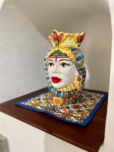 a statue of a woman with a crown on a shelf at Aeolian Apartments in Lipari