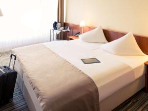 Ein Bett oder Betten in einem Zimmer der Unterkunft Mercure Hotel Riesa Dresden Elbland