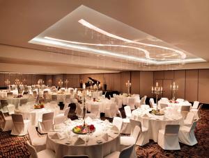 a ballroom with white tables and white chairs at Hyatt Regency Köln in Cologne