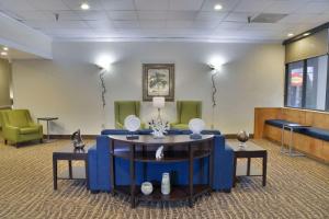 a waiting room with blue chairs and a table at Comfort Inn Gold Coast in Ocean City
