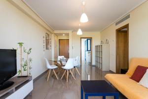 A television and/or entertainment centre at ApartUP Patacona Orchard Views