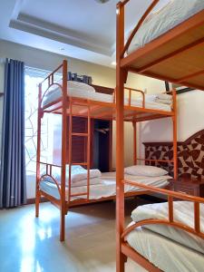 a bedroom with three bunk beds in a room at Ha Long Starlight Hostel in Ha Long