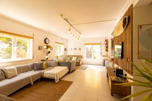 a living room with a couch and a table at Pineapple Surf House in Peniche