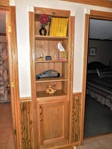 a wooden book shelf in a room with a bed at ML246 Spacious Condo Mtn & Lake views fireplace in Snowshoe