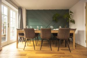 a dining room with a wooden table and chairs at Upton Grange Townhouse in Chester